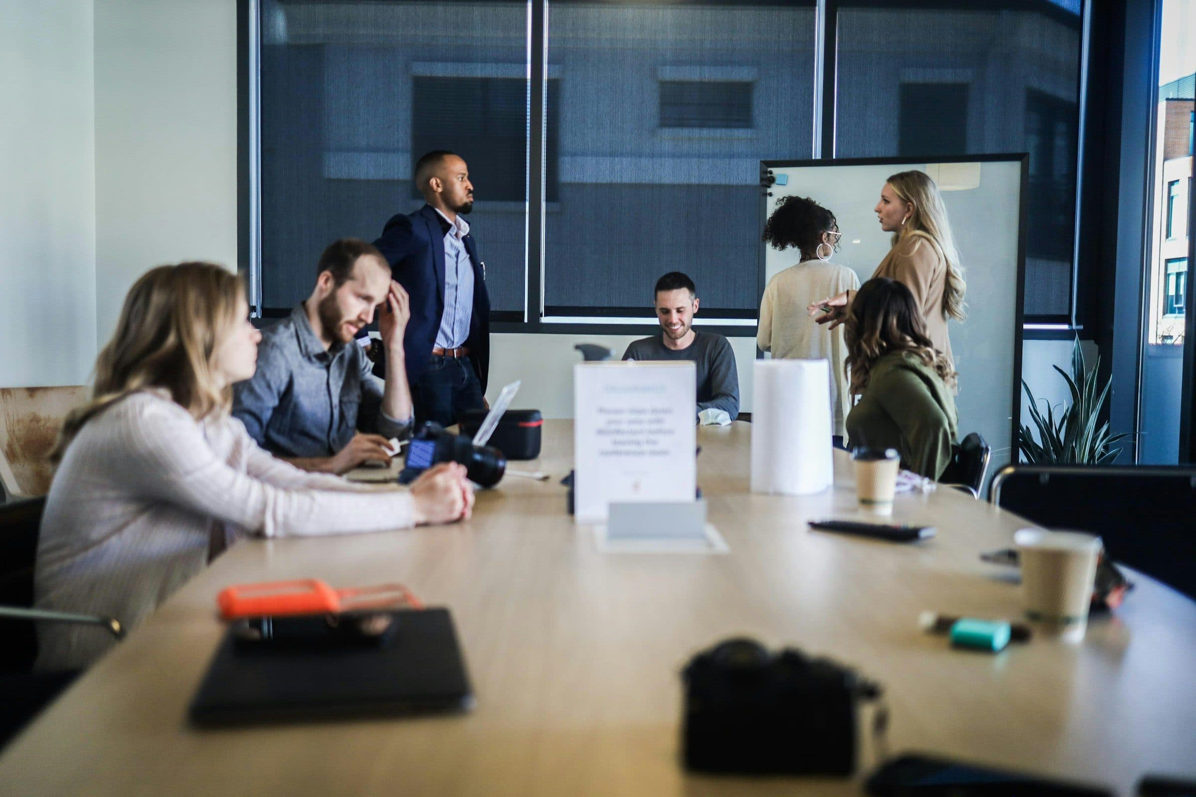 Team seated around a large meeting table during a working session